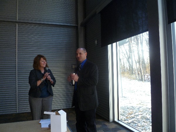 Sgt. Dave Willson, Alaska State Troopers, receives an AFCEA mug from Gillian Dezzutto, chapter vice president, at the November luncheon.